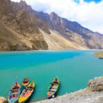 Colorful boats in the emerald waters of Attabad Lake