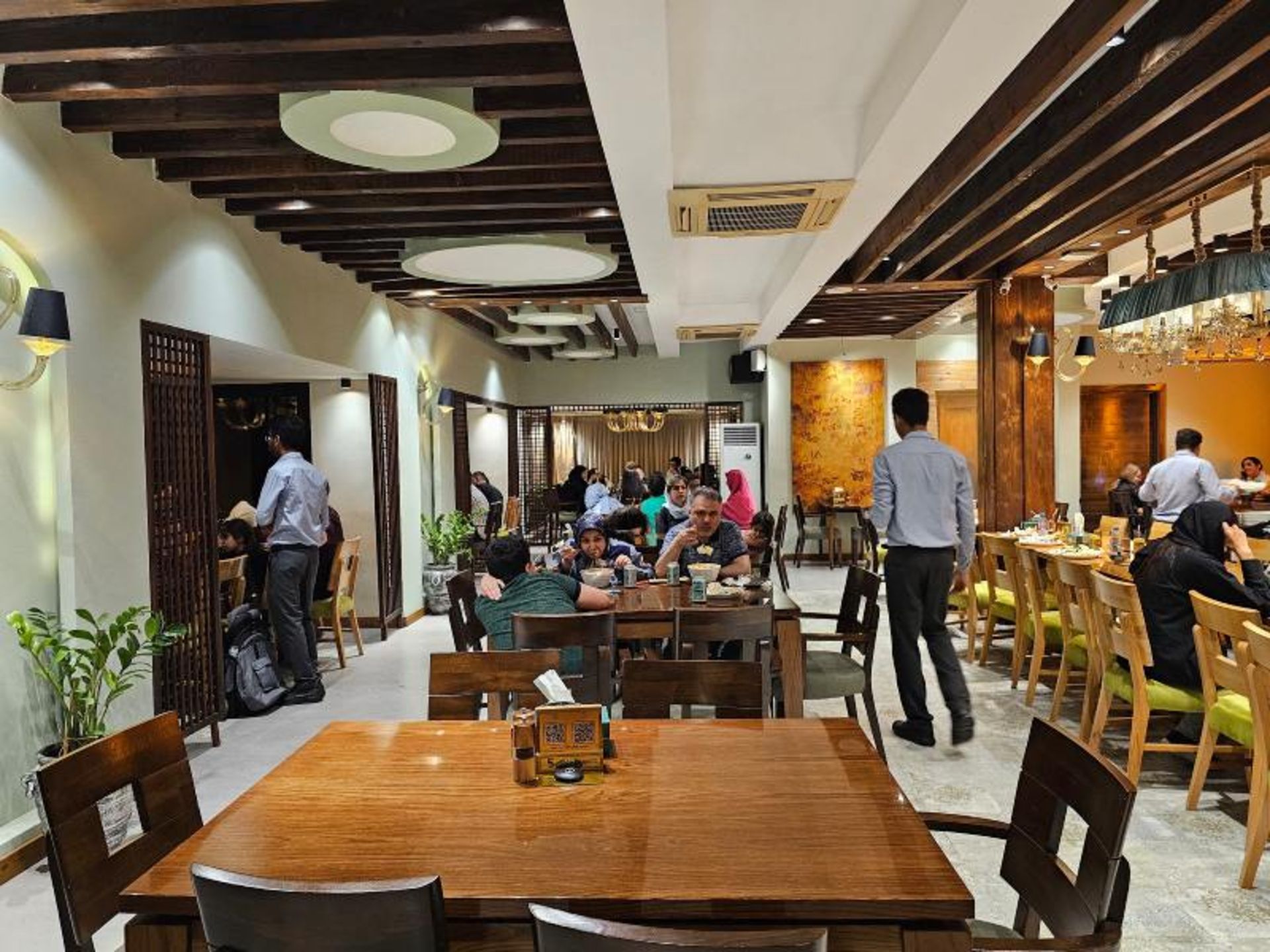 Guests in the ierior of Darchin Kish cafe restaura