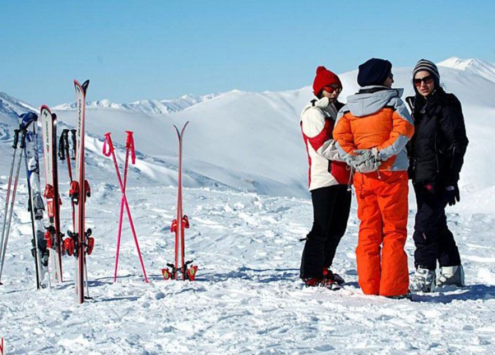 Women with ski equipme at the resort's ski station