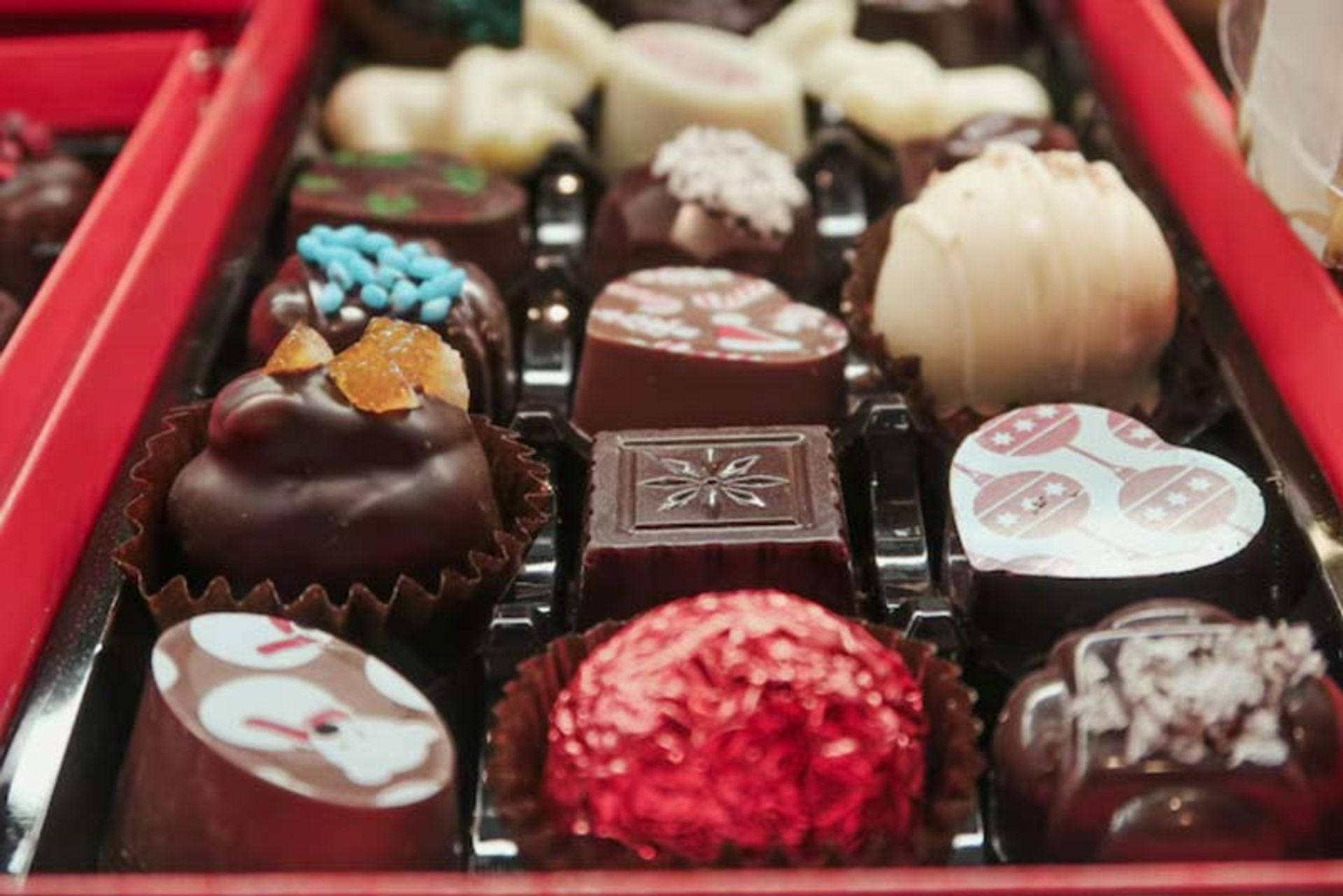 A box of handmade and decorated chocolates in differe flavors