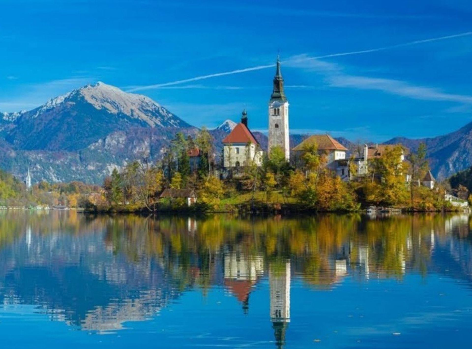 A high castle on an island in Slovenia and in the middle of the Alps