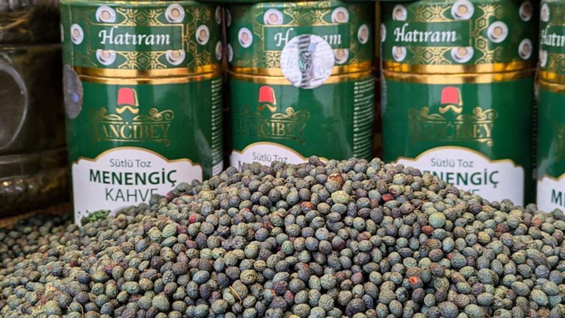 Raw, green pods on fro of packaged cans