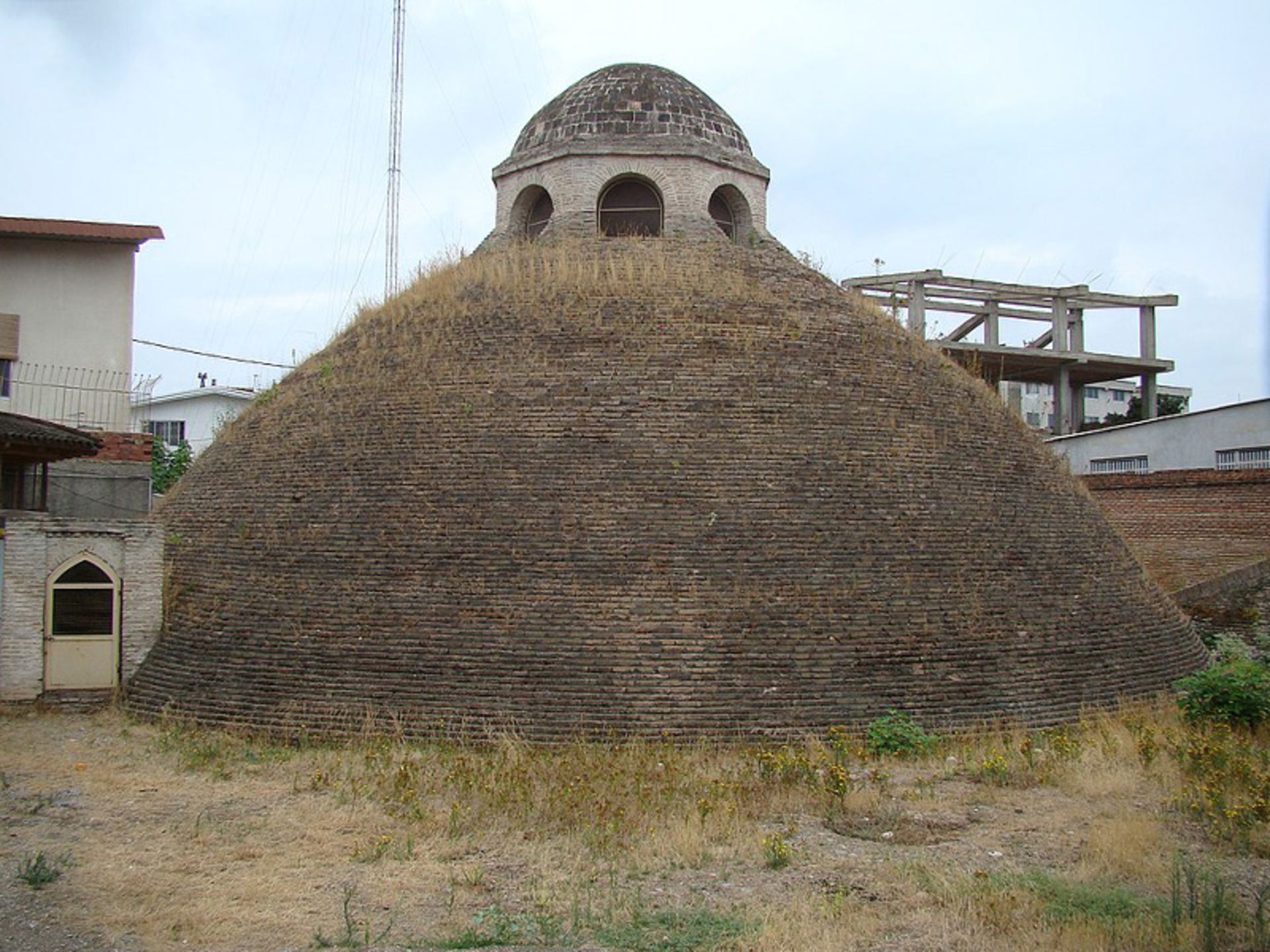 The brick roof of the New Sari reservoir in the middle of the urban fabric