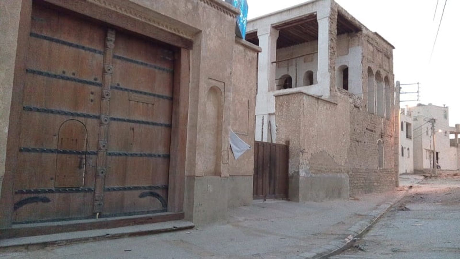 Wooden door and straw walls of Golestan Bushehr school