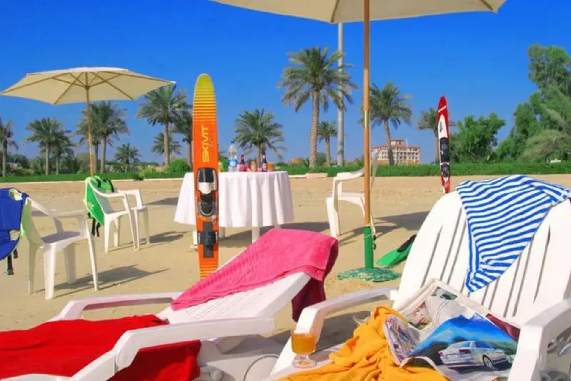 White chairs and towels at Mr. Kish Beach