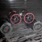 A close-up of the special wheels and drilling tanks of a lunar rover