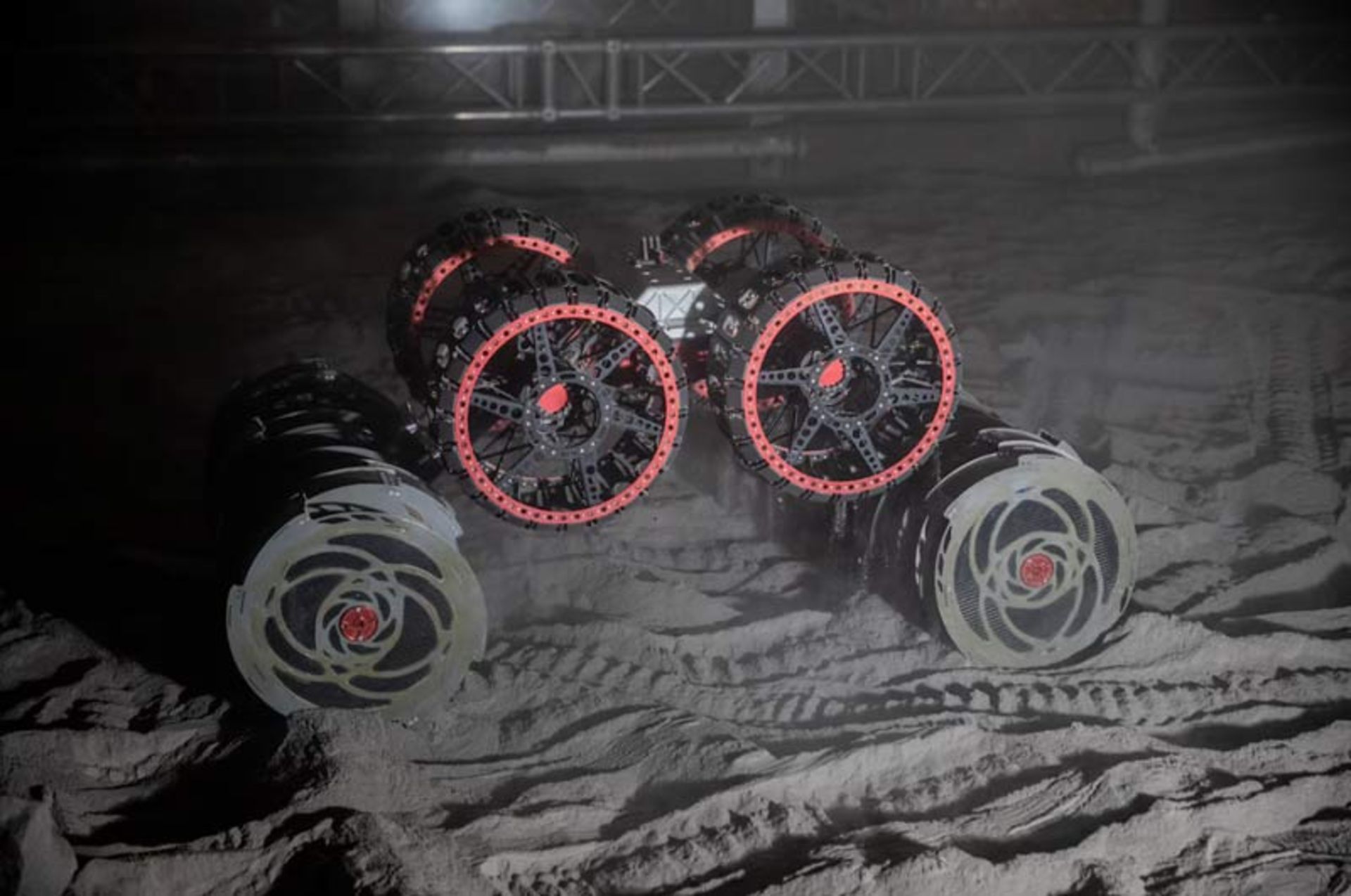 A close-up of the special wheels and drilling tanks of a lunar rover