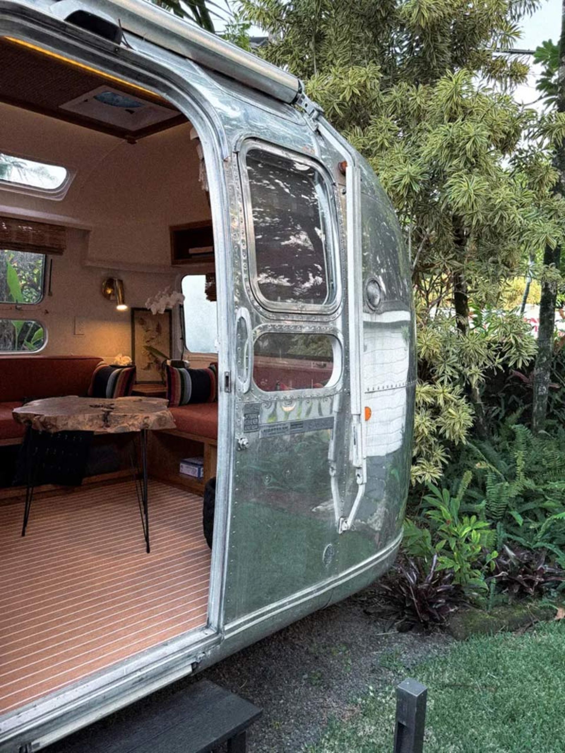 Airstream caravan opening and showing luxury ierior decoration and wooden flooring