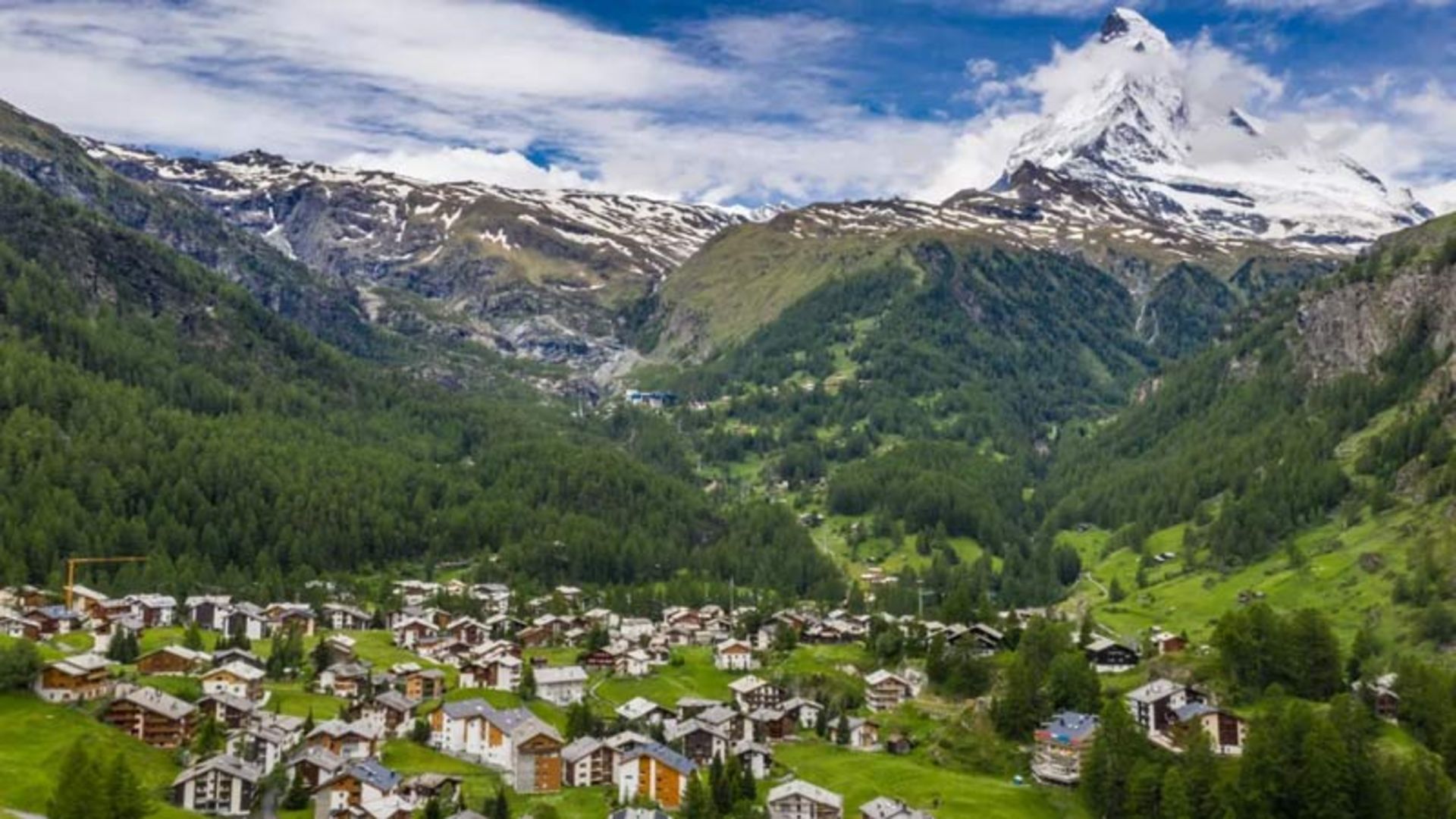 A mouain village at the foot of a snowy peak