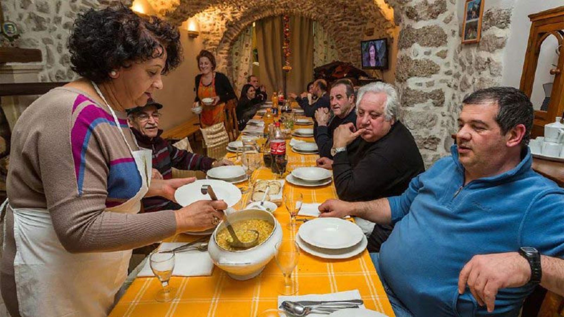 A woman serving soup at the Panarda festival