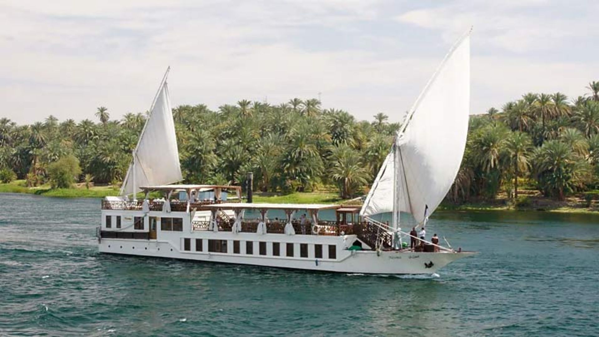 A traditional Egyptian sailboat with two large white sails