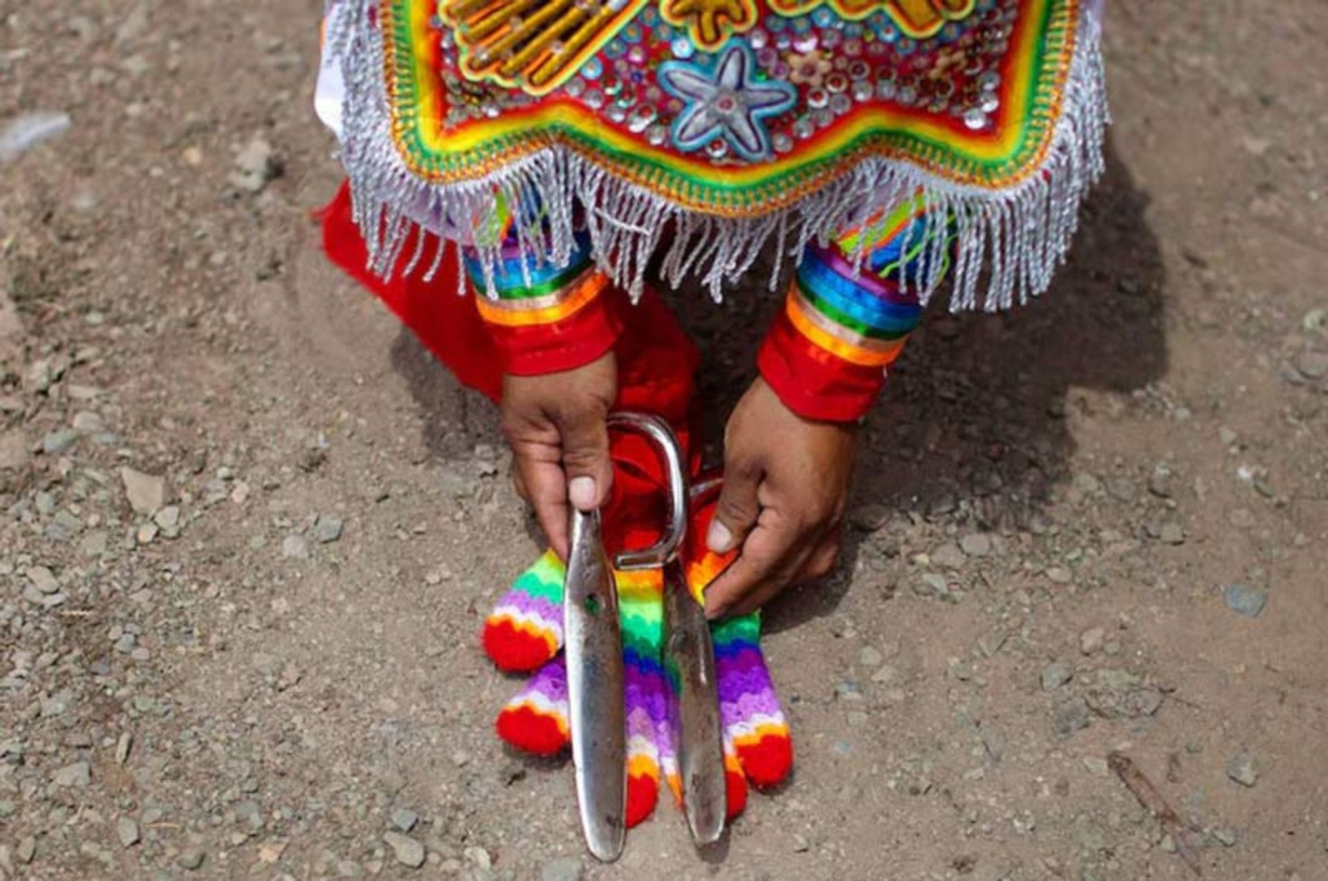 An image of scissors in the hands of a dancer